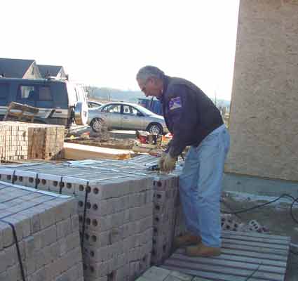 Al picking up bricks