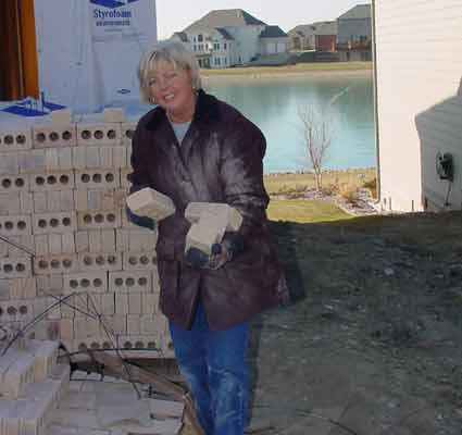 Al's wife picking up bricks