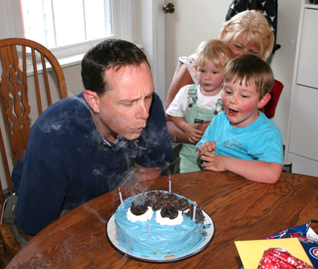 Jack is excited to see his Daddy blow out the relighting candles<br>while Owen is concerned with the candles that won't go out. 