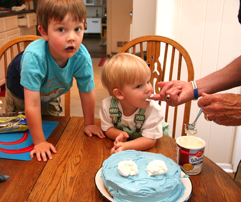 Owen tastes the icing for Cookie Monster's eyes.