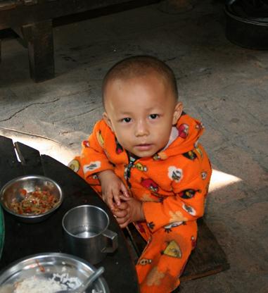 Small Burmemse boy eating