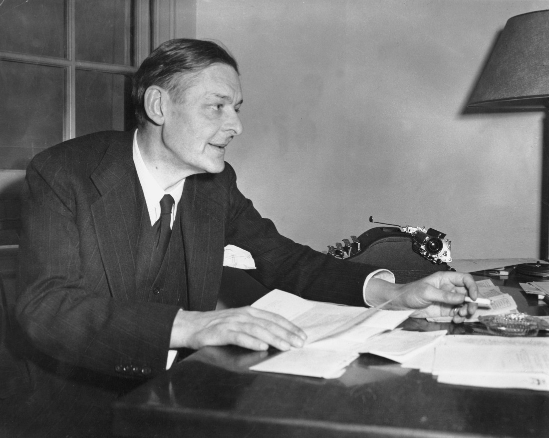 This is T. S. Eliot with his writing, typewriter, and cigarette.  He died due to lung problems related to his smoking.