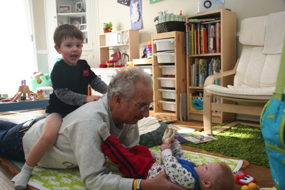 Jack is bouncing on my back while Owen shows me his giraffe.