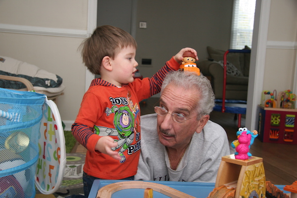 Jack puts a train on Papa's head